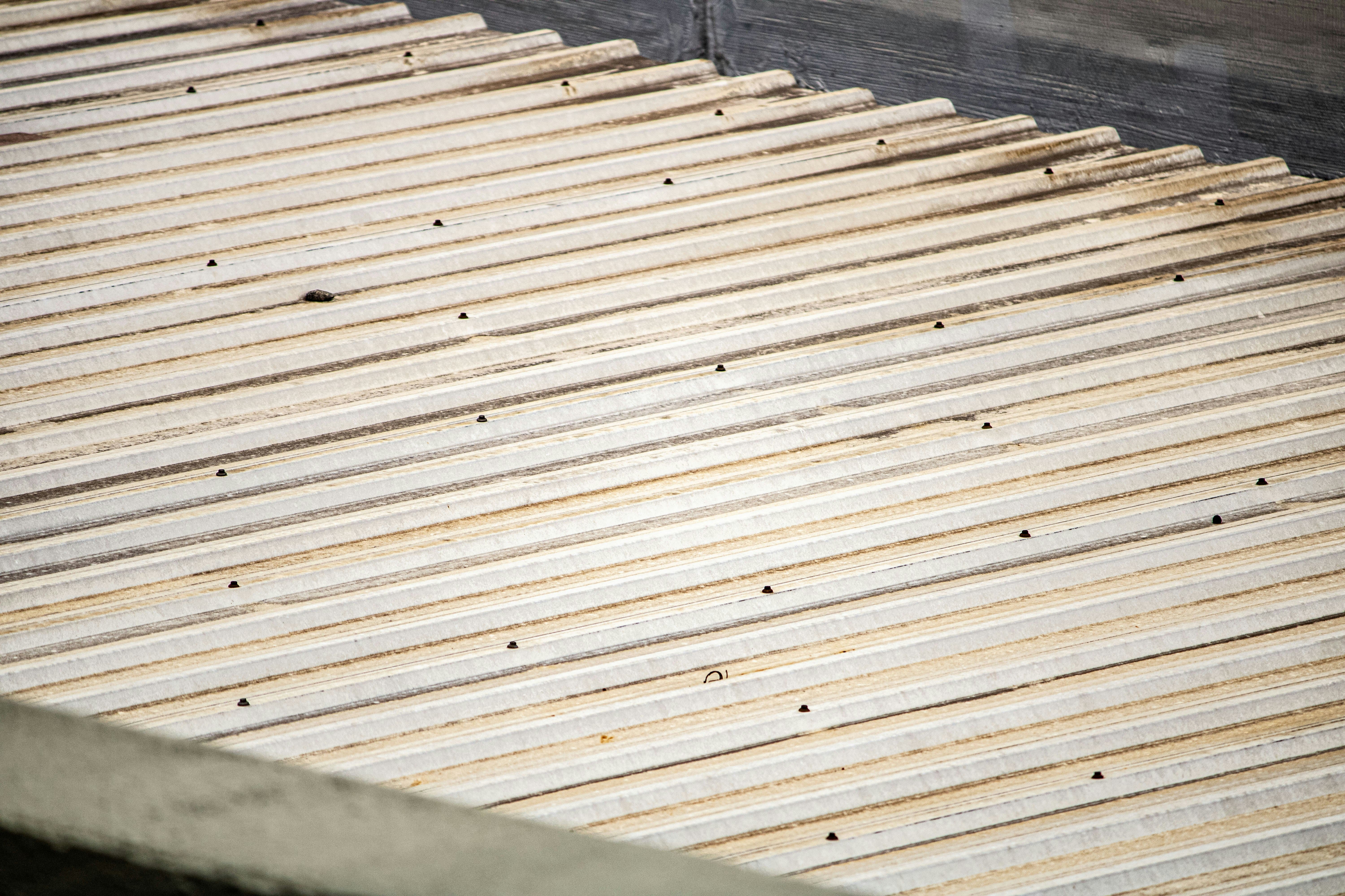 Metal roofing sheet in need of replacement covered with dirt and debris