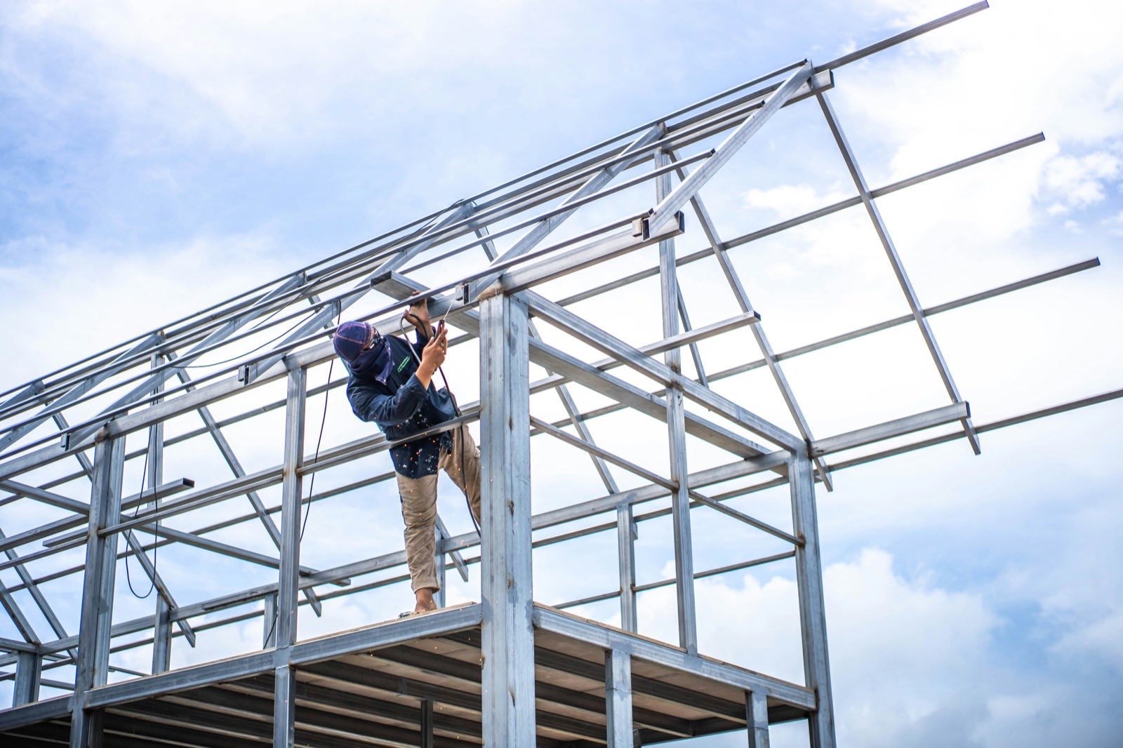 construction worker assembling a metal frame
