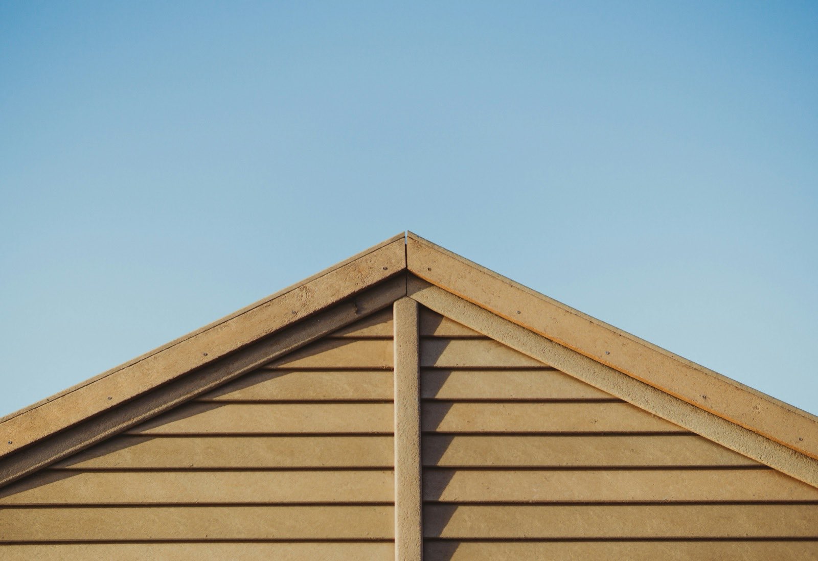 brown wooden house roof under blue sky