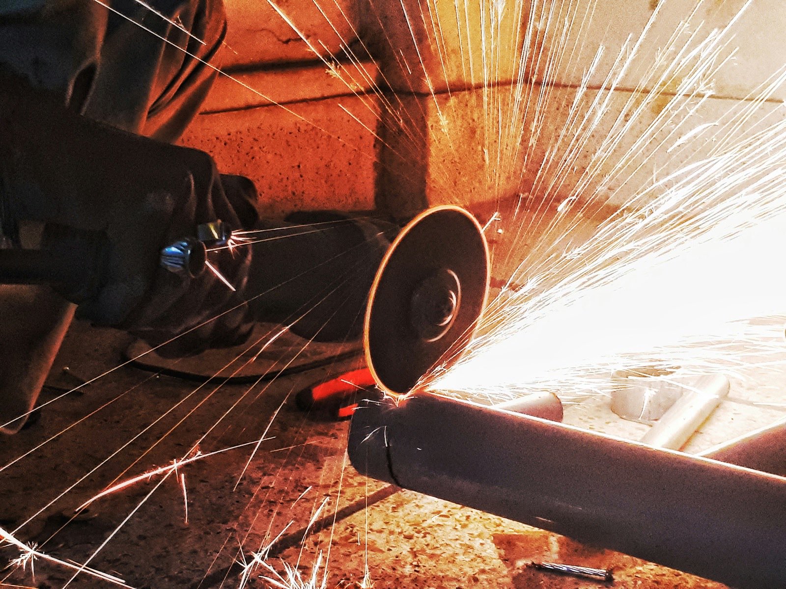 person grinding steel