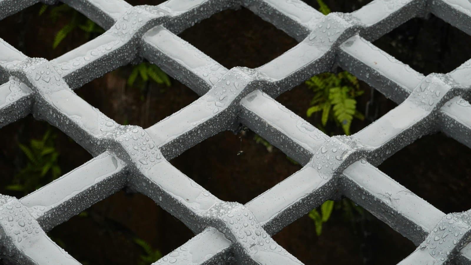 water droplets collected on a grey metal surface