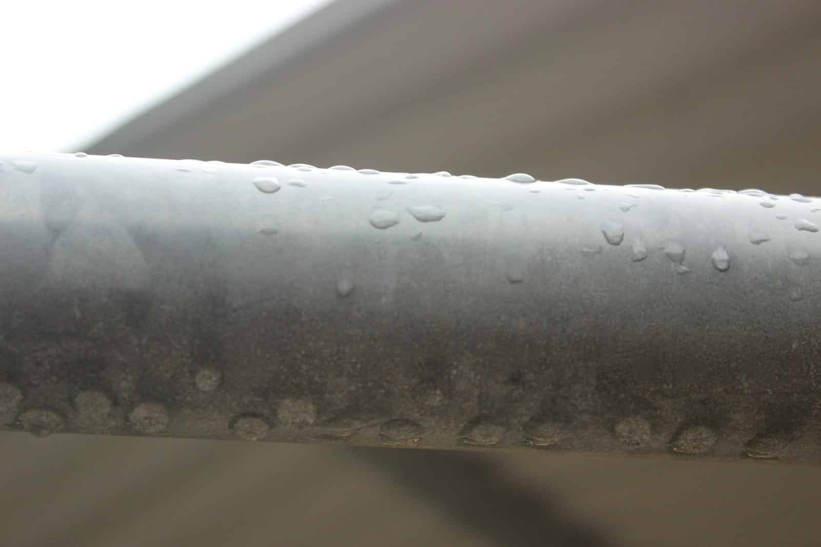 Metal Roof Dripping Water: Causes and Fixes Raindrops on a metal pipe