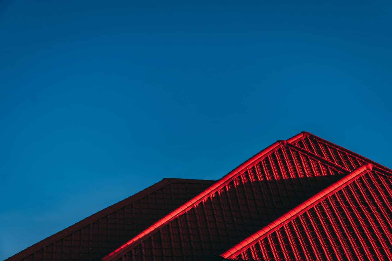 a pitched metal roof against a blue sky